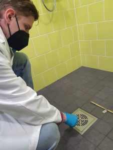 A student is taking a test from the floor drain.