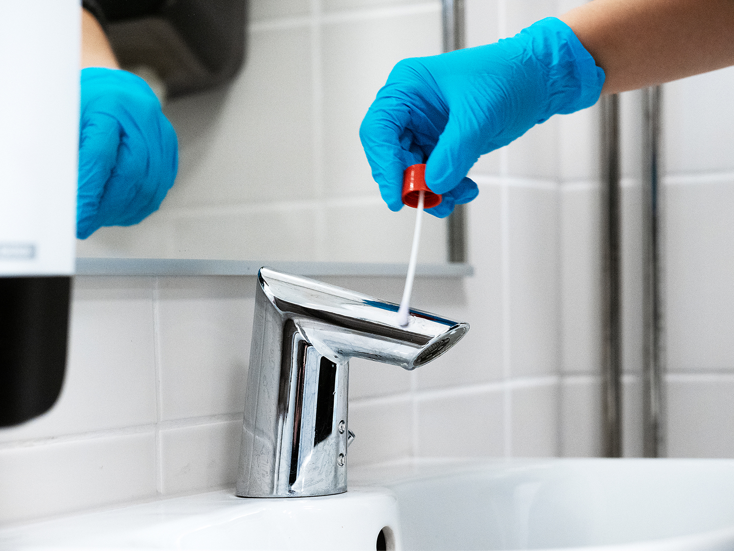 A sample is taken from the tap with a cotton swab.