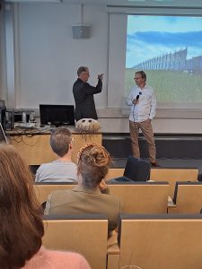 Martti Latva and Teemu Heikkinen chat on stage.