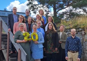 The staff of the WANDER research center poses on the stairs.