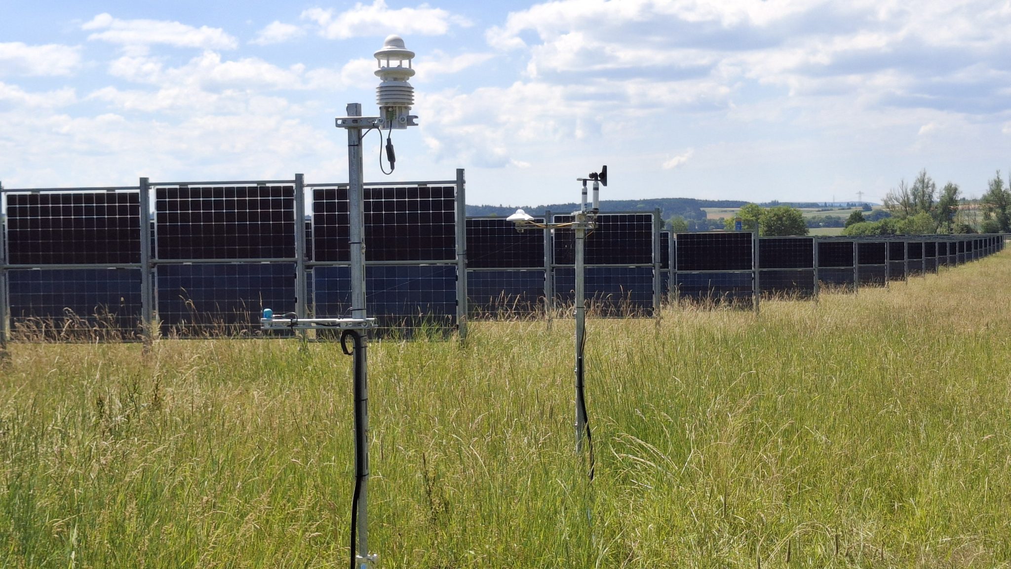 Kuvassa viljapellon keskellä on aurinkosähköpaneeleja.